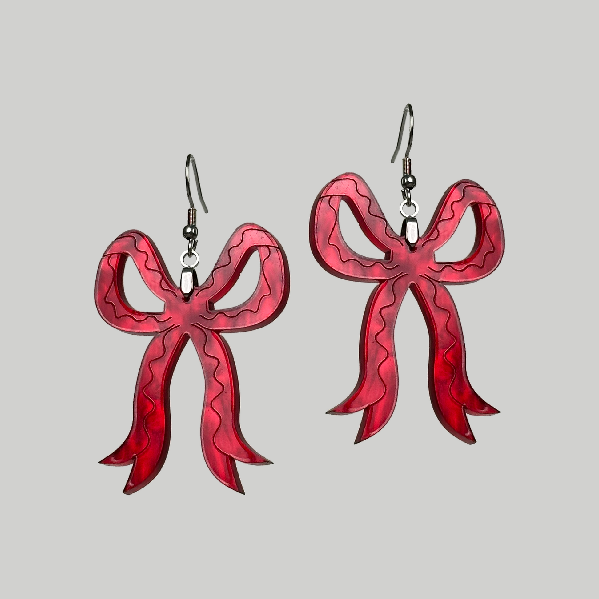 Red Bow Earrings: Chic and playful, these earrings feature stylish red bows for a touch of festive and fashionable charm.