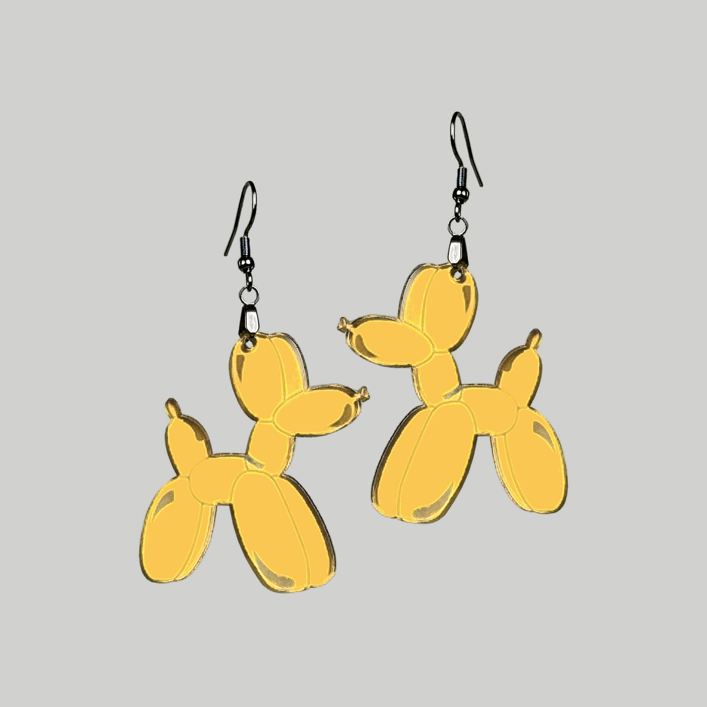 Adorable dog-shaped balloon animal earrings, adding a touch of fun and innocence to your fashion statement.
