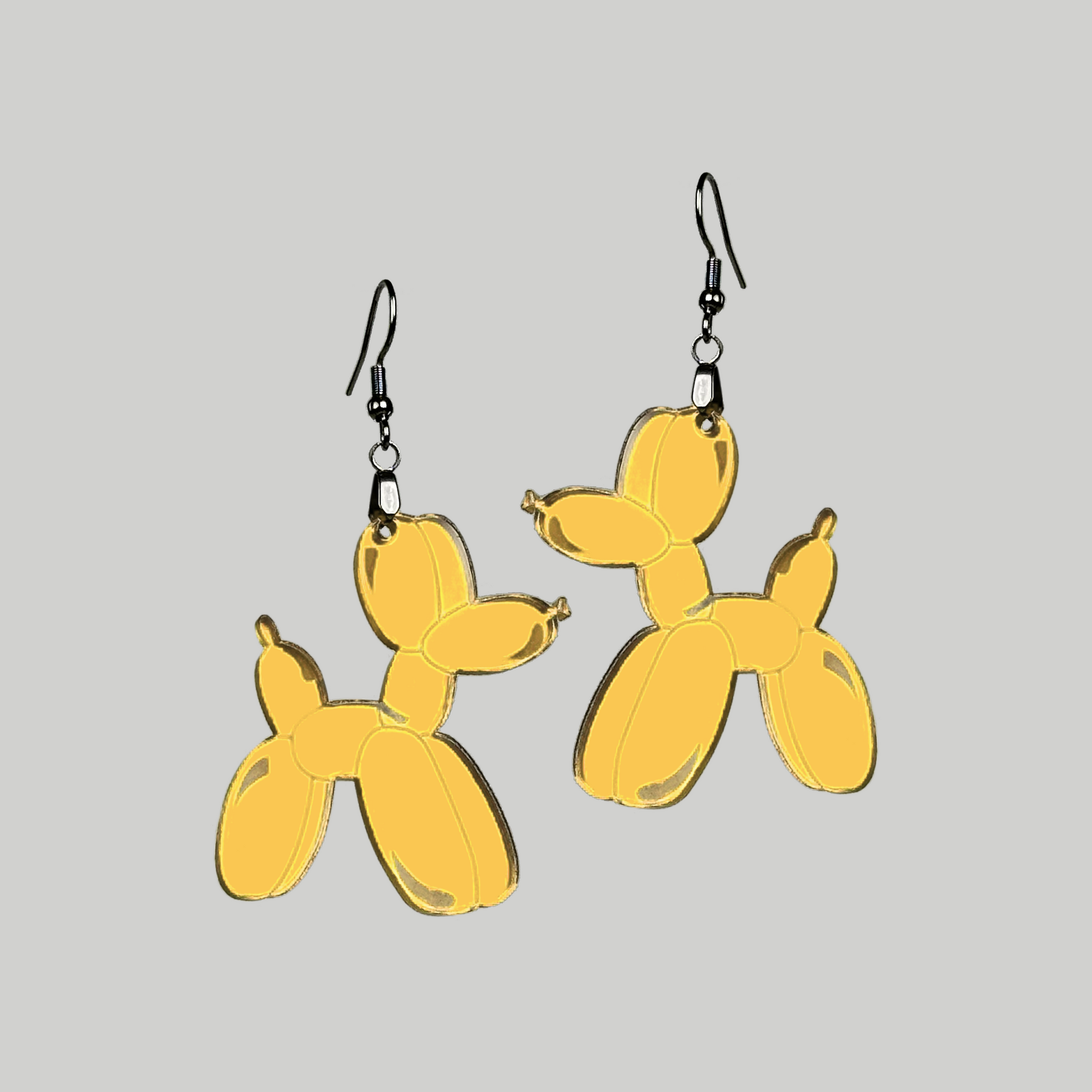 Adorable dog-shaped balloon animal earrings, adding a touch of fun and innocence to your fashion statement.