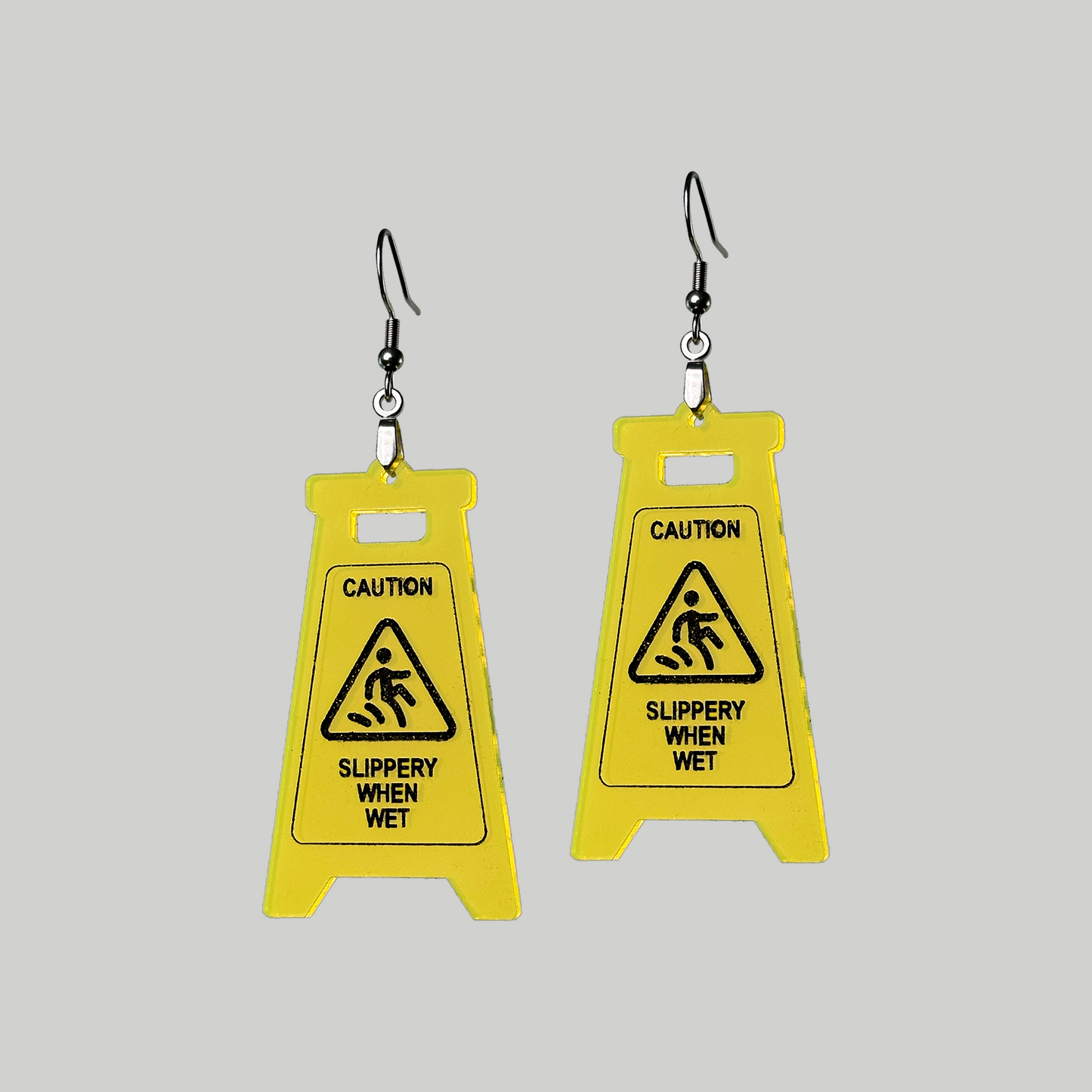 Slippery When Wet Earrings: Playful and unique, these earrings feature caution sign in a fun yellow and black color.