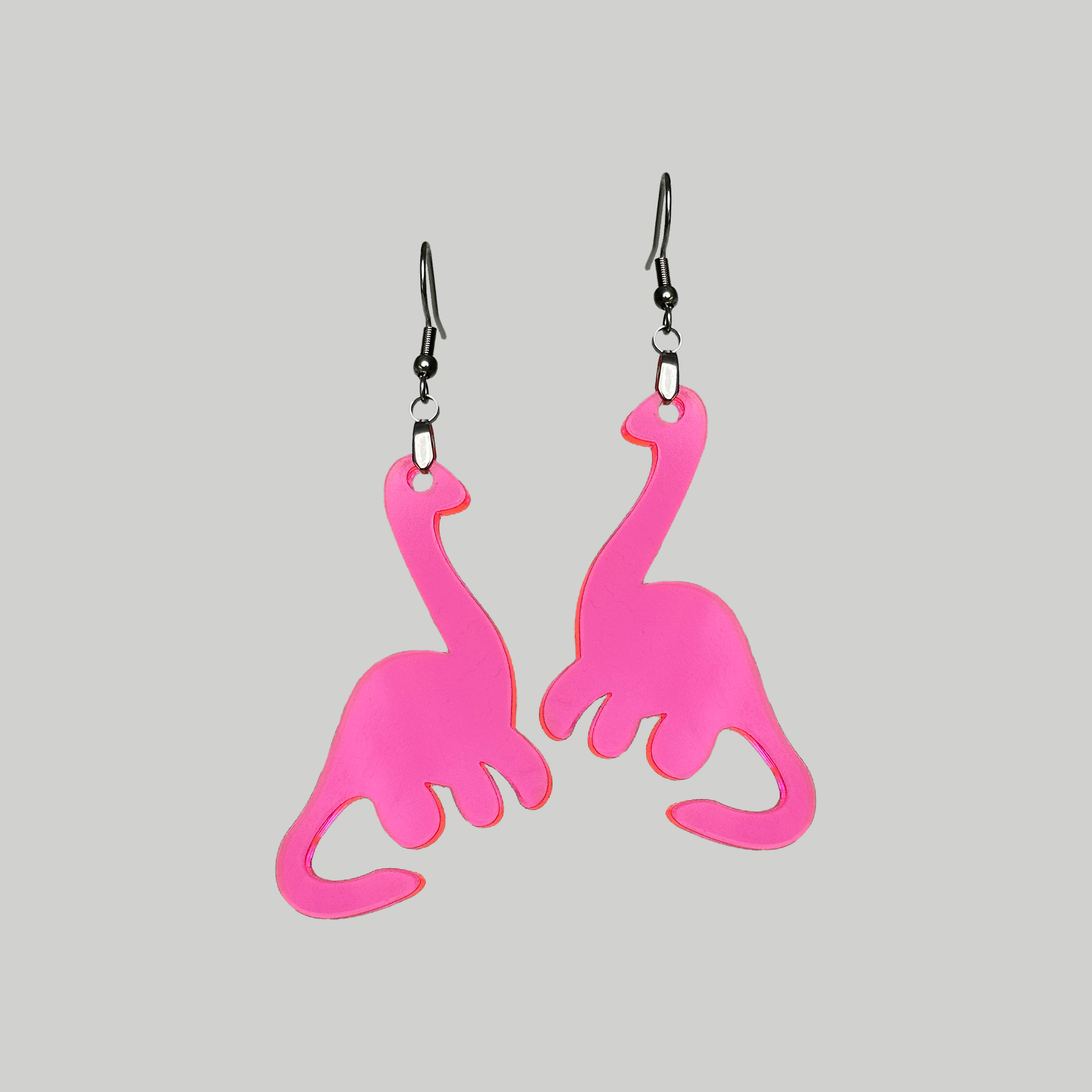 Pink Brachiosaurus dinosaur earrings, a delightful and charming accessory to accentuate your style with a touch of prehistoric whimsy.