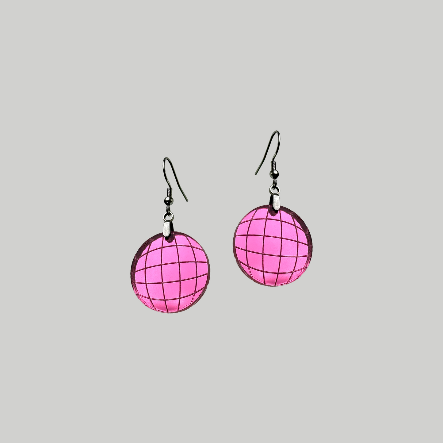 Mirrored acrylic earrings with a disco ball design, capturing attention with their shiny surface, adding a touch of dazzling allure to your ensemble.